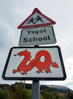A 20mph sign outside a school in Welsh and English.