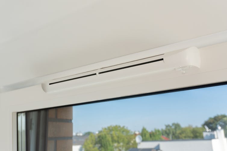A trickle vent above a window.