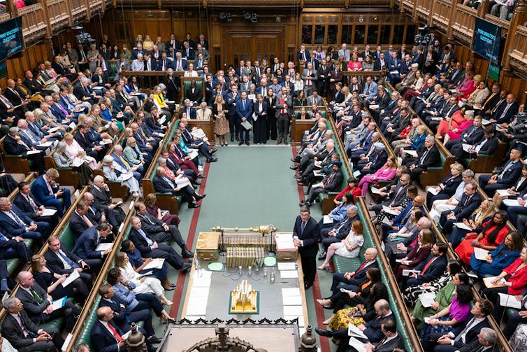 andy burnham in the commons during his first prime minister's questions surrounded by hundreds of mps on either side of the chamber.