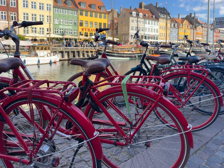 Red bikes lined up in Nyhavn, Copenhagen.