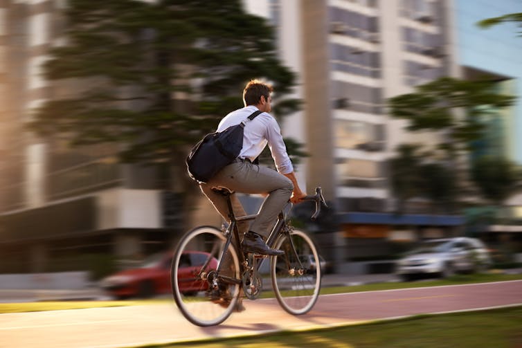 Man on bike in a suit.