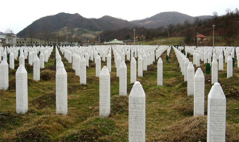 Gravestones at the Srebrenica Genocide Memorial, commemorating 8,372 victims of massacre committed by Bosnian Serb forces under command of Ratko Mladić in 1995. Photo by Michael Büker, via Wikimedia Commons, CC BY-SA 3.0.