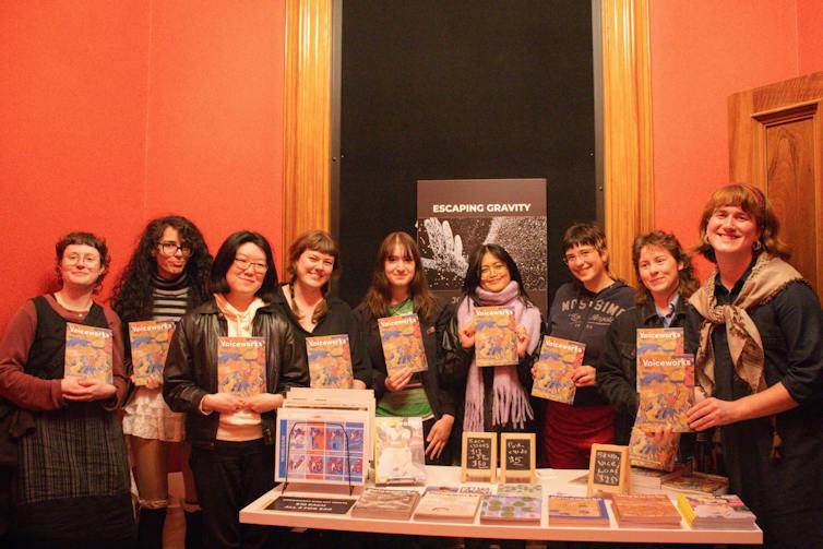 Young people holding copies of the magazine, Vocieworks.