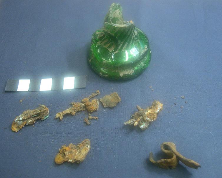 A green early 19th-century witch bottle from Lincolnshire and its contents.