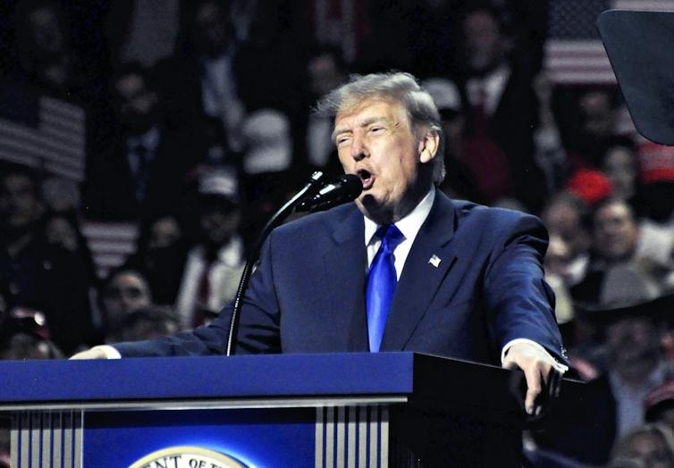 US president Donald Trump speaks at a podium.