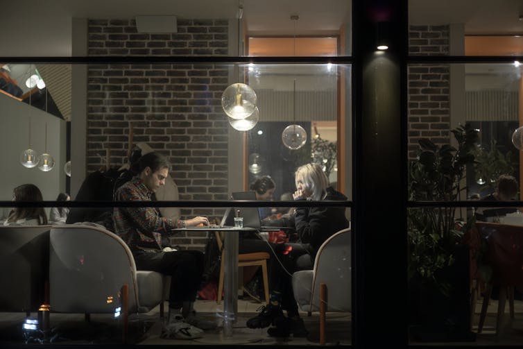 People working on their laptops in a cafe in Kyiv.