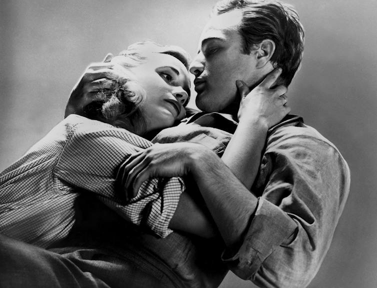 The pair embrace.