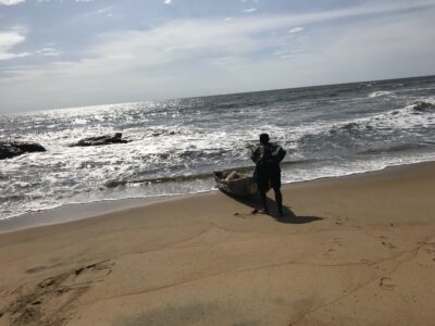 Fisherman-with-a-wooden-boast-at-Ebodje-Beach