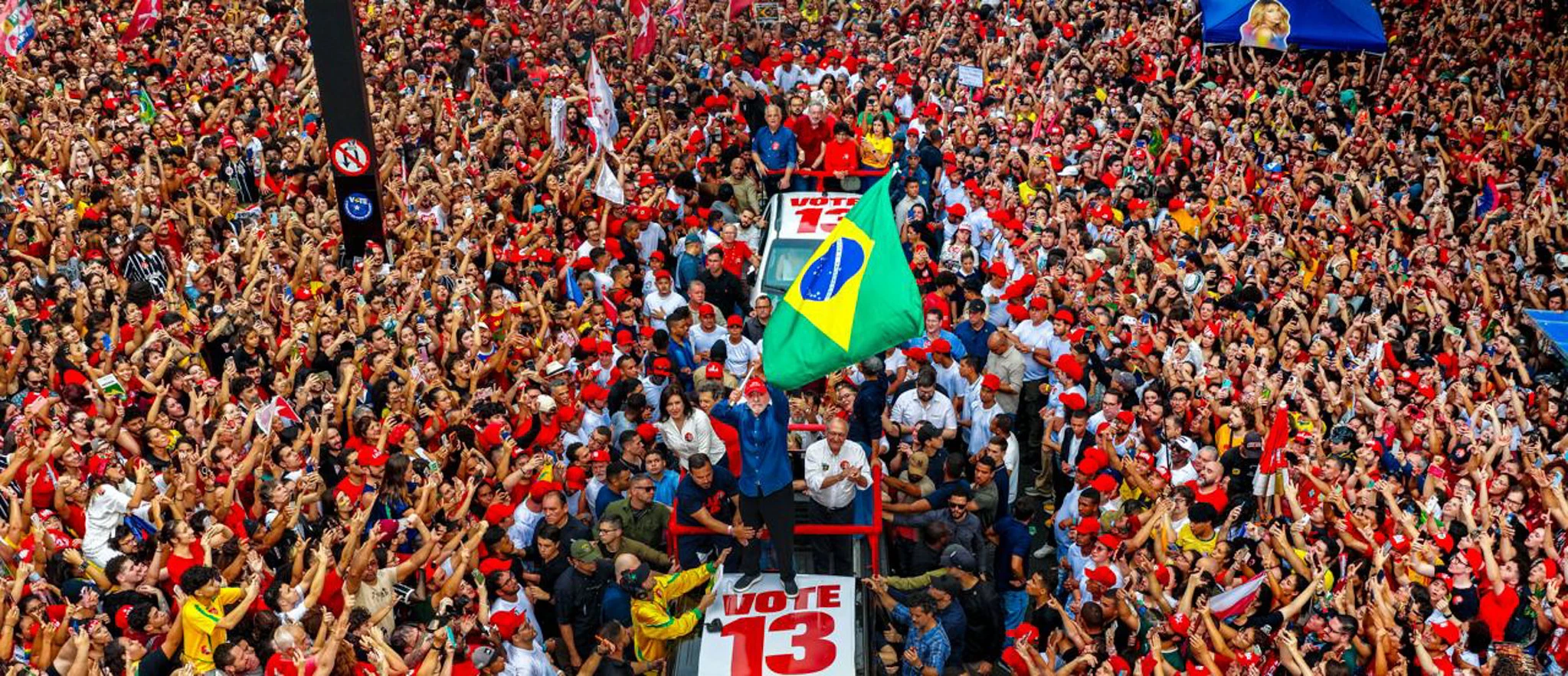 Lula waves Brazil's flag surrounded by a crowd of supporters in São Paulo, during the campaign. 
