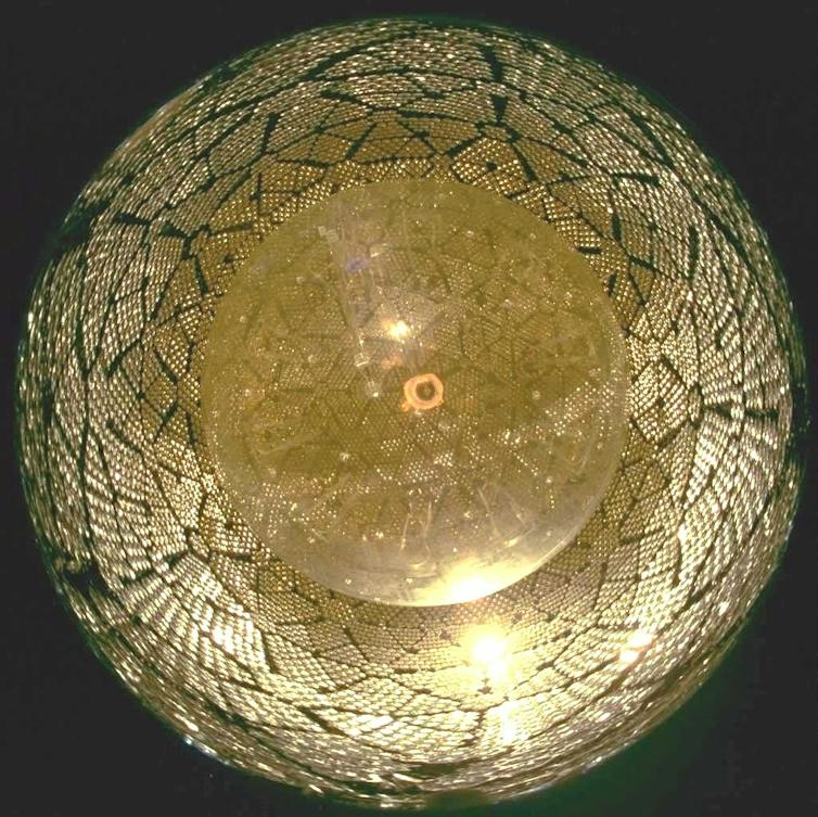 A spherical chamber lined with detector equipment.