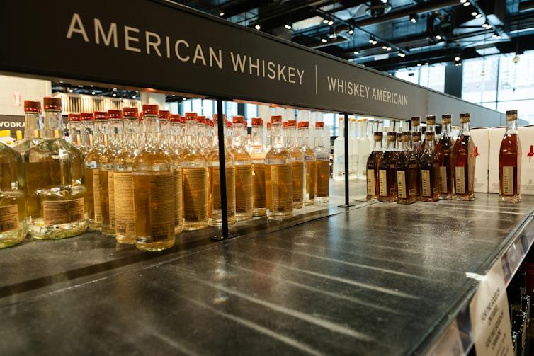 A half-empty shelf of American whiskey