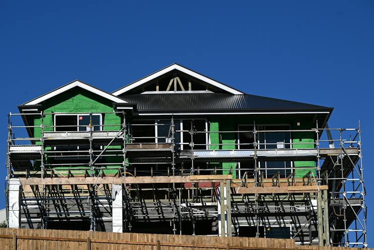 Scaffolding surrounds a new home which is still under construction.