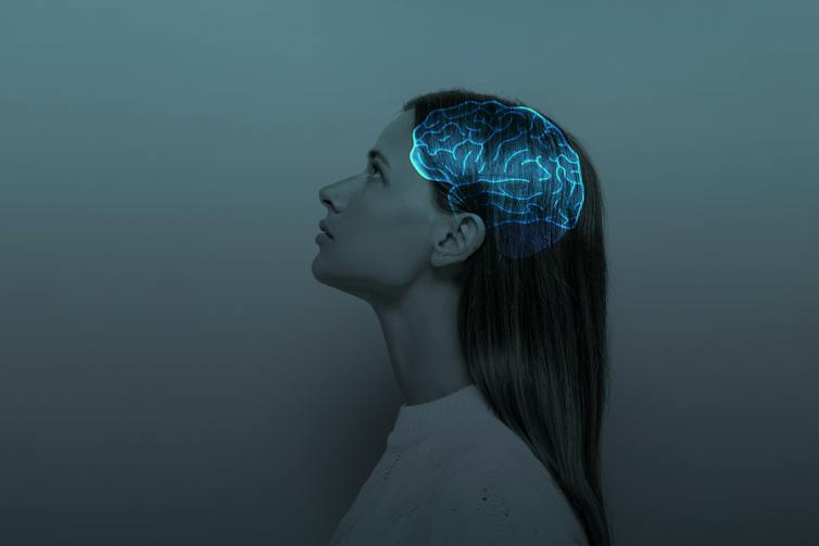 Image of woman from profile view overlayed with glowing brain